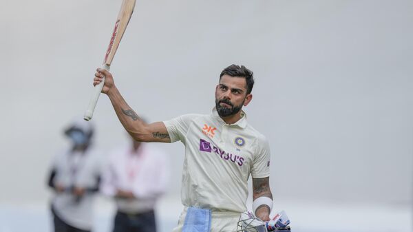 India's Virat Kohli raises his bat to acknowledge the crowd as he walks back to pavilion after his dismissal during the fourth day of the fourth cricket test match between India and Australia in Ahmedabad, India, Sunday, March 12, 2023. - Sputnik India