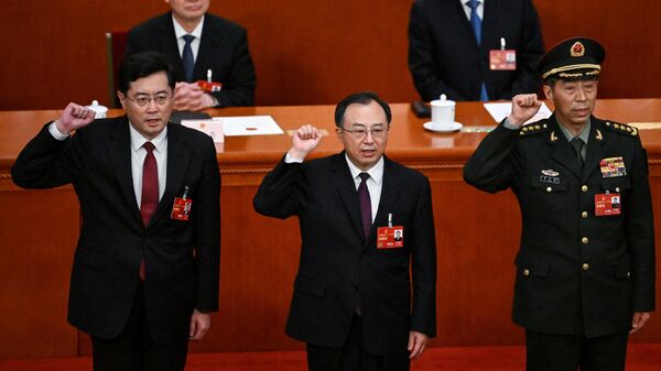 (L-R) Newly-elected Chinese state councilor Qin Gang, state councilor and secretary-general of the State Council Wu Zhenglong, state councilor Li Shangfu swear an oath after they were elected during the fifth plenary session of the National People's Congress (NPC) at the Great Hall of the People in Beijing on March 12, 2023. - Sputnik भारत