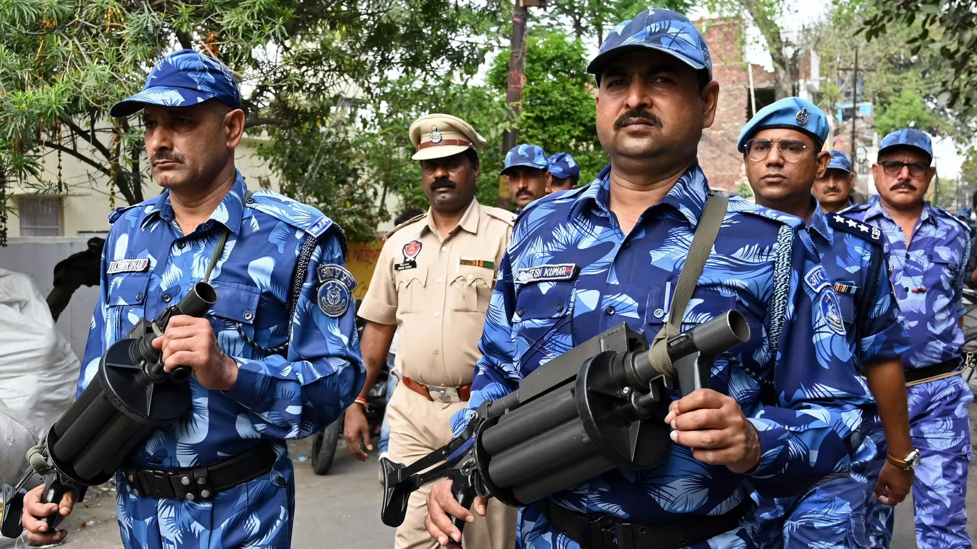 India's Rapid Action Force (RAF) personnel patrol along a street during a hunt for Sikh separatist, in Amritsar on March 30, 2023. 