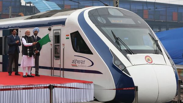 In this photo taken on February 15, 2019, Indian Prime Minister Narendra Modi (2nd L) flags off India's first semi-high speed express train Vande Bharat Express at New Delhi Railway Station.  - Sputnik India
