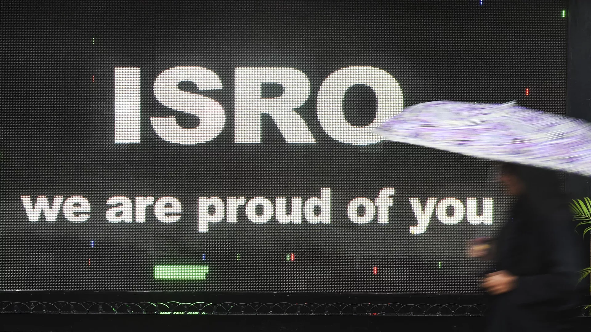 A pedestrian walks past a digital display congratulating Indian Space Research Organisation (ISRO) in Mumbai on September 7, 2019.