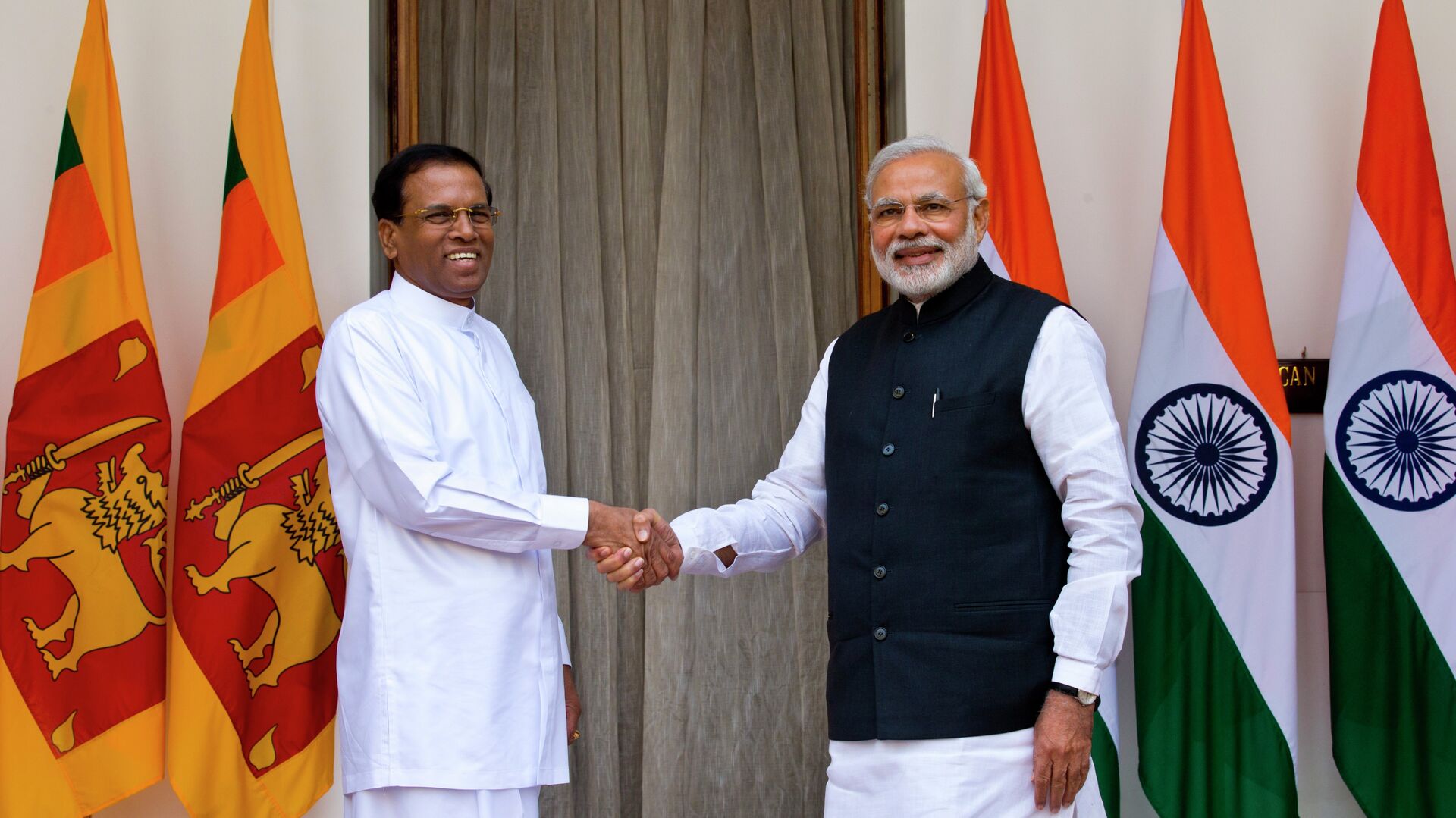 Sri Lanka’s President Maithripala Sirisena, left, and Indian Prime Minister Narendra Modi shake hands as they pose for photos before their meeting in New Delhi, India, Monday, Feb. 16, 2015 - Sputnik India, 1920, 28.10.2023