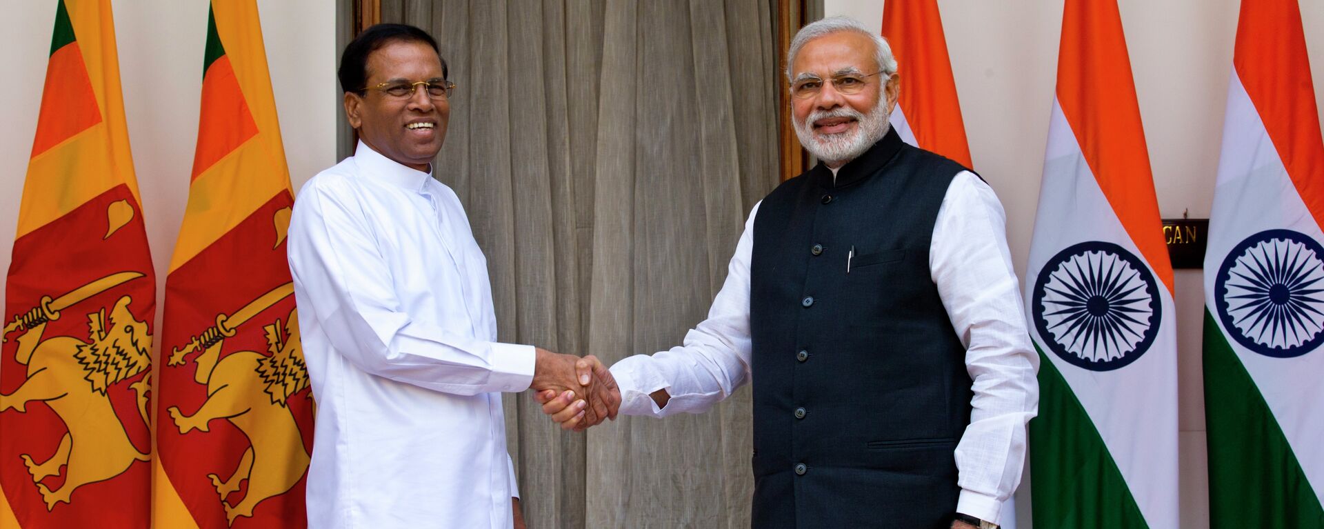 Sri Lanka’s President Maithripala Sirisena, left, and Indian Prime Minister Narendra Modi shake hands as they pose for photos before their meeting in New Delhi, India, Monday, Feb. 16, 2015 - Sputnik India, 1920, 28.10.2023
