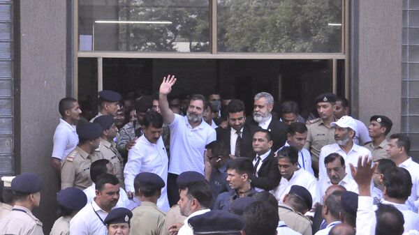 India's opposition Congress party leader Rahul Gandhi waves to his supporters as he leaves the court, in Surat, India, Monday, April 3, 2023. - Sputnik India