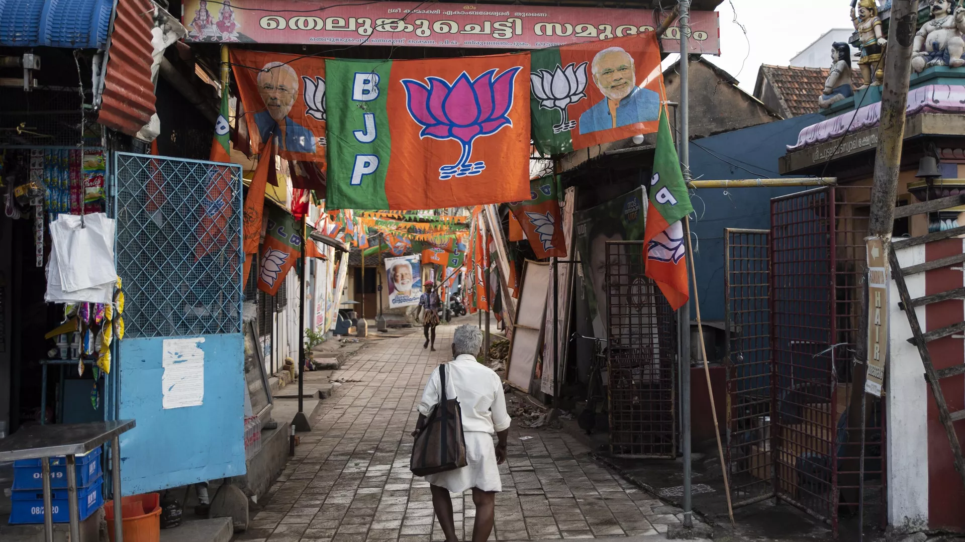 Bharatiya Janata Party (BJP) flags are displayed at a street inhabited by members of the Telugu Chetti community in Thiruvanathapuram, Kerala state, India, Saturday, April 3, 2021.