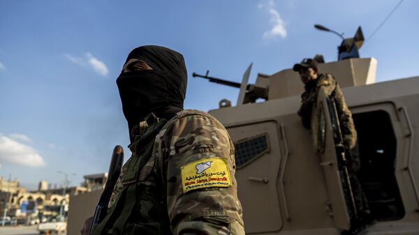 U.S.-backed Syrian Democratic Forces (SDF) fighters stand guard at Al Naeem Square, in Raqqa, Syria, Monday, Feb. 7, 2022. - Sputnik India