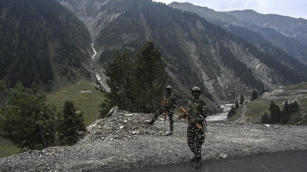 Indian paramilitary troopers stand guard near the entrance of the Zojila tunnel under construction which connects Srinagar to the union territory of Ladakh, at Baltal, some 93 km northeast of Srinagar, on September 28, 2021. - Sputnik India