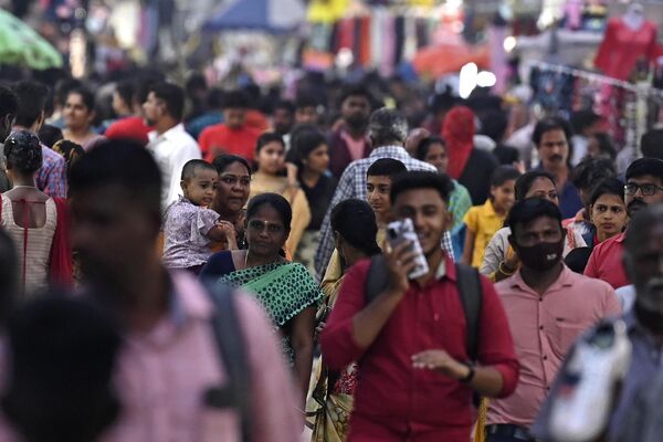 In this photograph taken on October 31, 2022, people walk through a crowded commercial street in Chennai. - Sputnik India