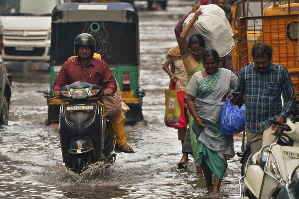 People commute through rain waters during pre-monsoon showers in Hyderabad, India, Monday, May 1, 2023. - Sputnik India