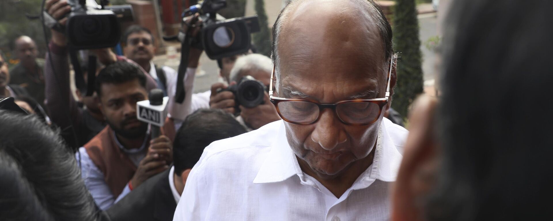 Media personnel surround Nationalist Congress Party leader Sharad Pawar as he arrives on the opening day of the winter session of the Parliament in New Delhi, India, Monday, Nov.18, 2019. - Sputnik India, 1920, 02.05.2023
