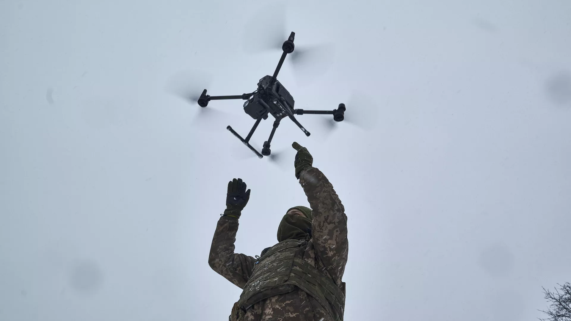 A Ukrainian soldier launches a drone