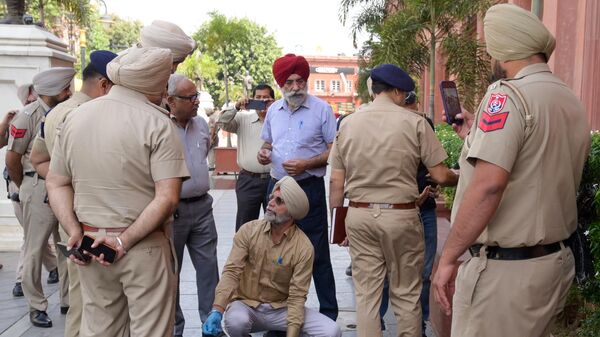 Punjab policemen inspect the site of a blast in Heritage Street near the Golden Temple in Amritsar on May 7, 2023. (Photo by Narinder NANU / AFP) - Sputnik India