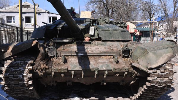 A serviceman of DPR People's Militia looks out of a tank in the city of Volnovakha - Sputnik India