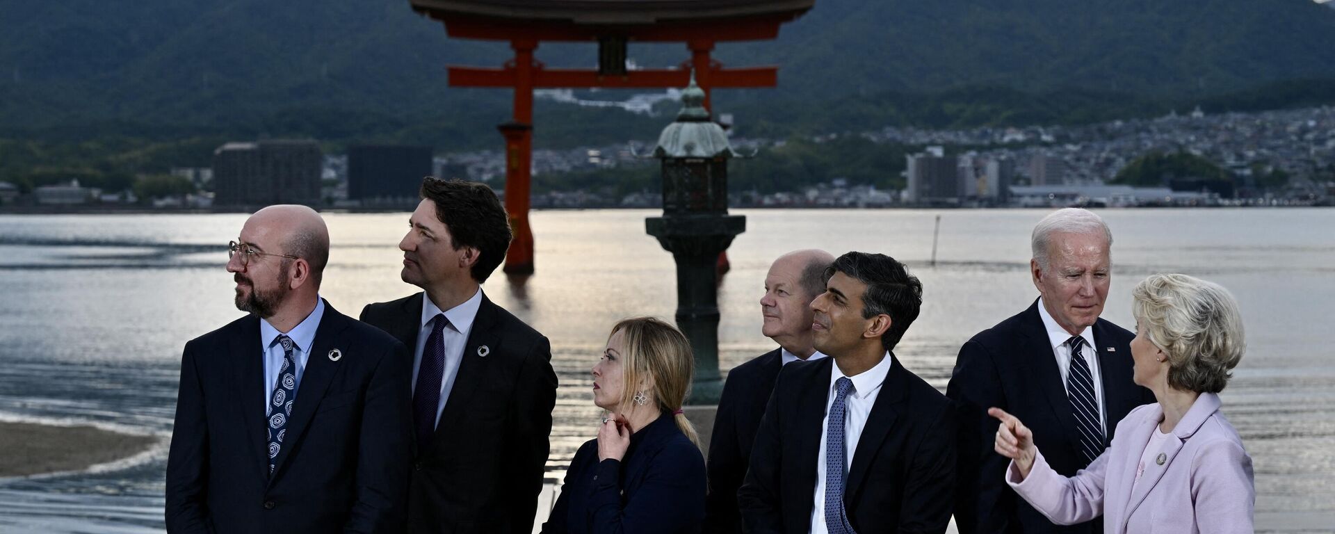 (L-R) President of the European Council Charles Michel, Canada's Prime Minister Justin Trudeau, Italy's Prime Minister Giorgia Meloni, Germany's Chancellor Olaf Scholz, Britain's Prime Minister Rishi Sunak, US President Joe Biden and European Commission President Ursula von der Leyen visit the Itsukushima Shrine on Miyajima Island in Hatsukaichi on May 19, 2023, during the G7 Leaders' Summit being held in Hiroshima. - Sputnik India, 1920, 20.05.2023