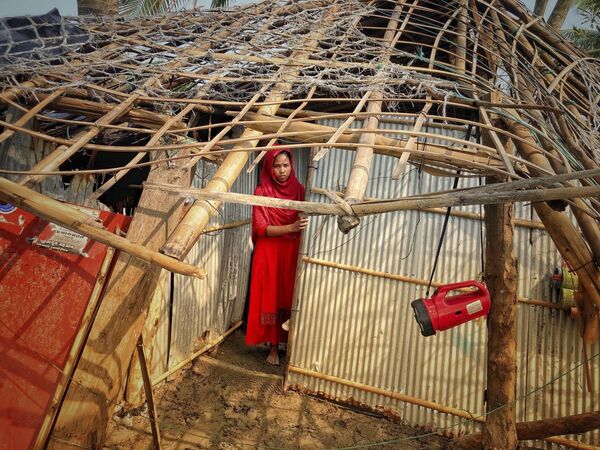 A woman surveys the damage caused to her home by Cyclone Mocha at Saint Martin island in Cox's Bazar, Bangladesh, Monday, May 15, 2023. - Sputnik India