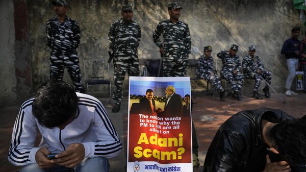 Members of opposition Congress party, demanding an investigation into allegations of fraud and stock manipulation by India's Adani Group display a placard with images of Indian businessman Gautam Adani and Indian Prime Minister Narendra Modi during a protest in New Delhi, India, Monday, Feb.6, 2023. - Sputnik India