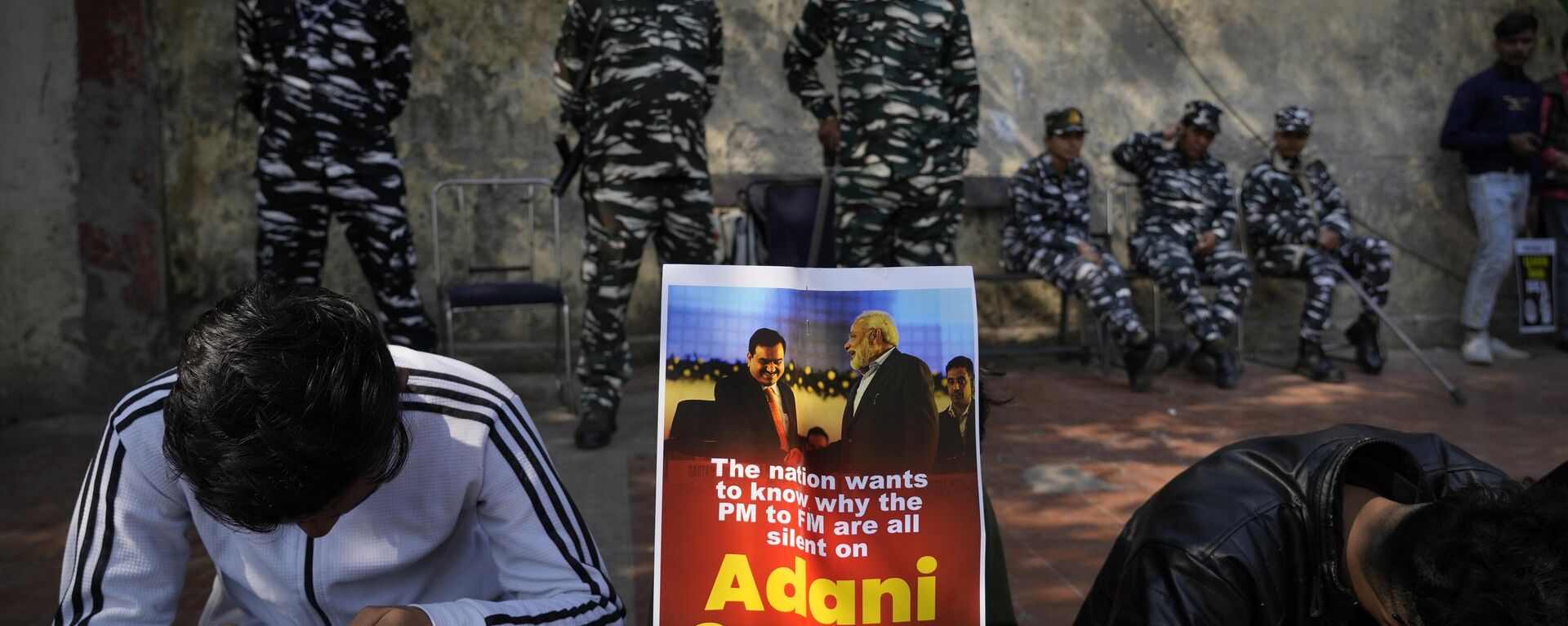 Members of opposition Congress party, demanding an investigation into allegations of fraud and stock manipulation by India's Adani Group display a placard with images of Indian businessman Gautam Adani and Indian Prime Minister Narendra Modi during a protest in New Delhi, India, Monday, Feb.6, 2023. - Sputnik India, 1920, 19.05.2023