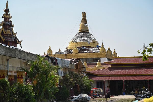 A man walks past a destroyed pagoda in Sittwe on May 17, 2023, in the aftermath of Cyclone Mocha's landfall.  - Sputnik India