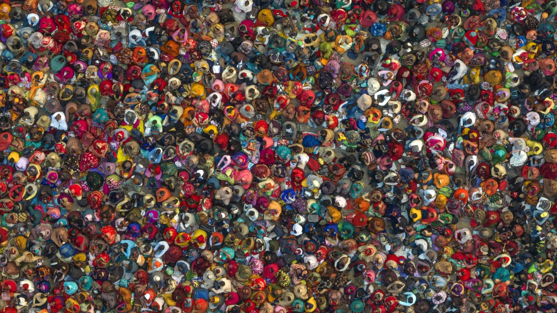 Hindu devotees listen to a religious leader at the Sangam, the confluence of the Ganges, Yamuna and mythical Saraswati rivers, during the annual traditional fair of Magh Mela festival, in Prayagraj, in the northern Indian state of Uttar Pradesh, Jan. 31, 2023.