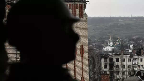A service member of Russia's private military company Wagner Group inspects a building in Artemovsk, also known as Bakhmut, as Russia's military operation in Ukraine continues, Donetsk People's Republic, Russia. - Sputnik India