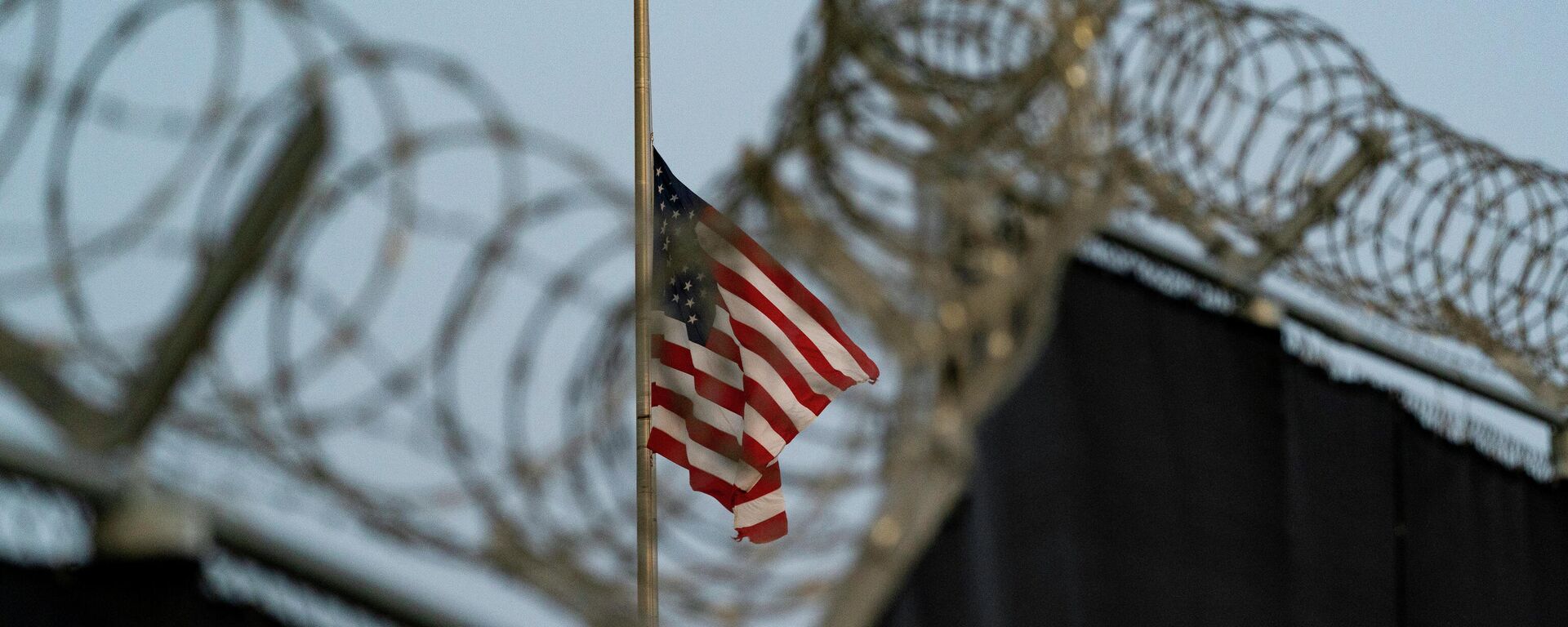 In this Aug. 29, 2021, file photo reviewed by U.S. military officials, a flag flies at half-staff in honor of the U.S. service members and other victims killed in the terrorist attack in Kabul, Afghanistan, as seen from Camp Justice in Guantanamo Bay Naval Base, Cuba. - Sputnik India, 1920, 25.05.2023