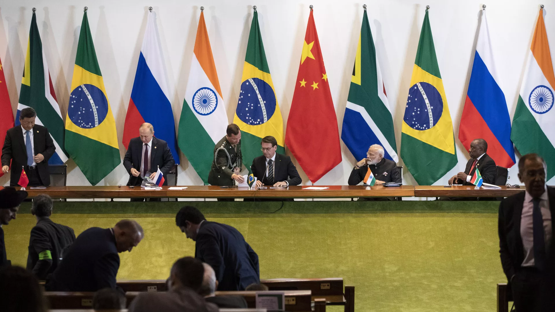 China's President Xi Jinping, left, Russia's President Vladimir Putin, second from left, Brazil's President Jair Bolsonaro, center, India's Prime Minister Narendra Modi, second from right, and South Africa's President Cyril Ramaphosa leave after a meeting with members of the Business Council and management of the New Development Bank during the BRICS emerging economies at the Itamaraty palace in Brasilia, Brazil, Thursday, Nov. 14, 2019.