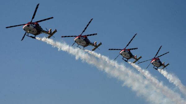 The Indian Air Force Sarang helicopter display team fly their HAL Dhruv aircraft in formation during an aerobatics show at the IAF headquarters in Srinagar - Sputnik भारत