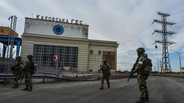 This photo taken on May 20, 2022 shows Russian servicemen standing guard near the Kakhovka Hydroelectric Power Plant, Kherson Oblast. - Sputnik India