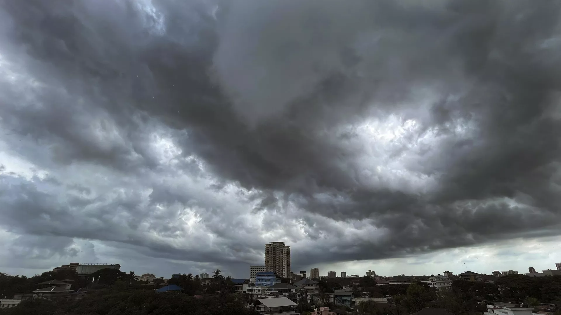 Rain clouds fill the city skyline in Kochi, southern Kerala state, India, Wednesday, June 7, 2023.