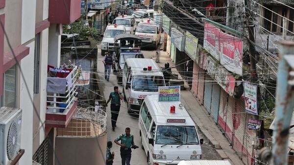 Ambulances guarded by police are moving through street in Dhaka, Bangladesh, Tuesday, July 26, 2016 - Sputnik India
