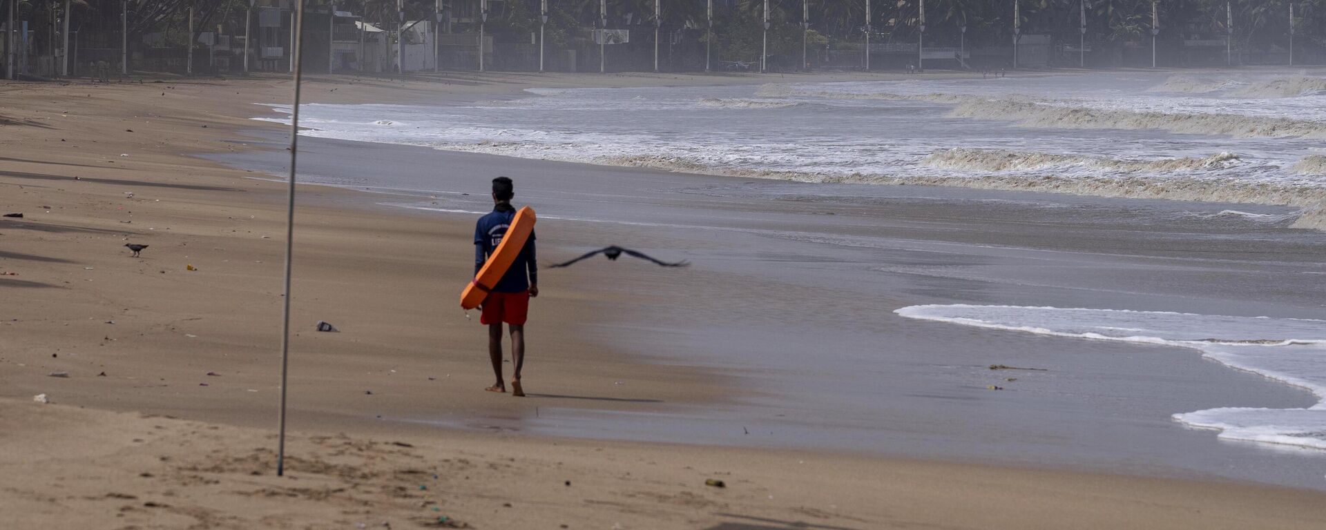 A lifeguard patrols during high tide at a deserted Juhu beach on the Arabian Sea cost in Mumbai, India, Tuesday, June 13, 2023. - Sputnik India, 1920, 13.06.2023