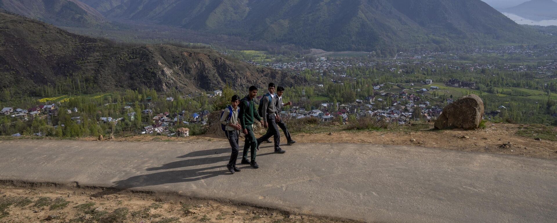 Kashmiri boys return home after attending their school in Astanpora on the outskirts of Srinagar, Tuesday, April 11, 2023. - Sputnik India, 1920, 15.06.2023