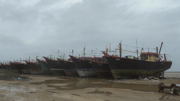 Fishing boats are seen secured on a concrete embankment at Jakhau Port of Kutch district in Gujarat state on June 14, 2023, ahead of cyclone Biparjoy landfall. - Sputnik India