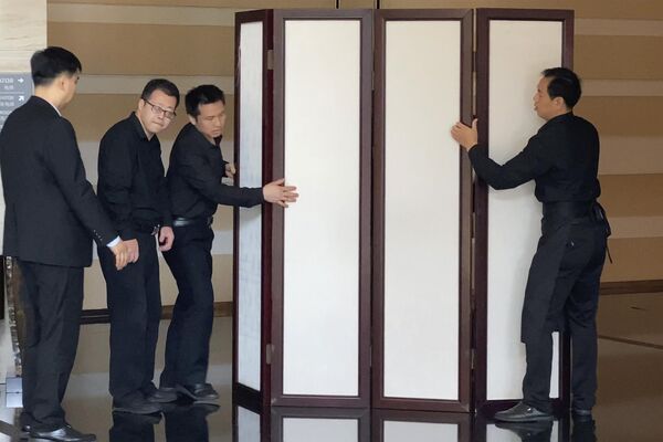 पत्रकारों को एंटनी ब्लिंकन को फिल्माने से रोकने के लिए होटल कर्मचारी स्क्रीन लगा रहे हैं। (AP Photo/Olivia Zhang) - Sputnik भारत