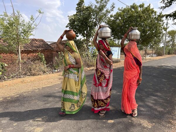 पीने के पानी से भरा घड़ा ले जाती महिलाएं (AP Photo/Rajesh Kumar Singh) - Sputnik भारत