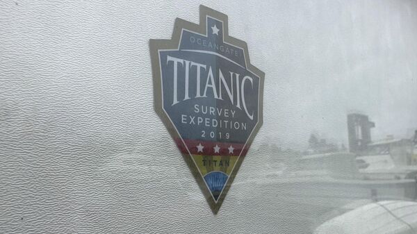 The logo for an OceanGate Expeditions 2019 Titanic expedition is seen on a marine industrial warehouse office door in Everett, Wash., Tuesday, June 20, 2023. - Sputnik India