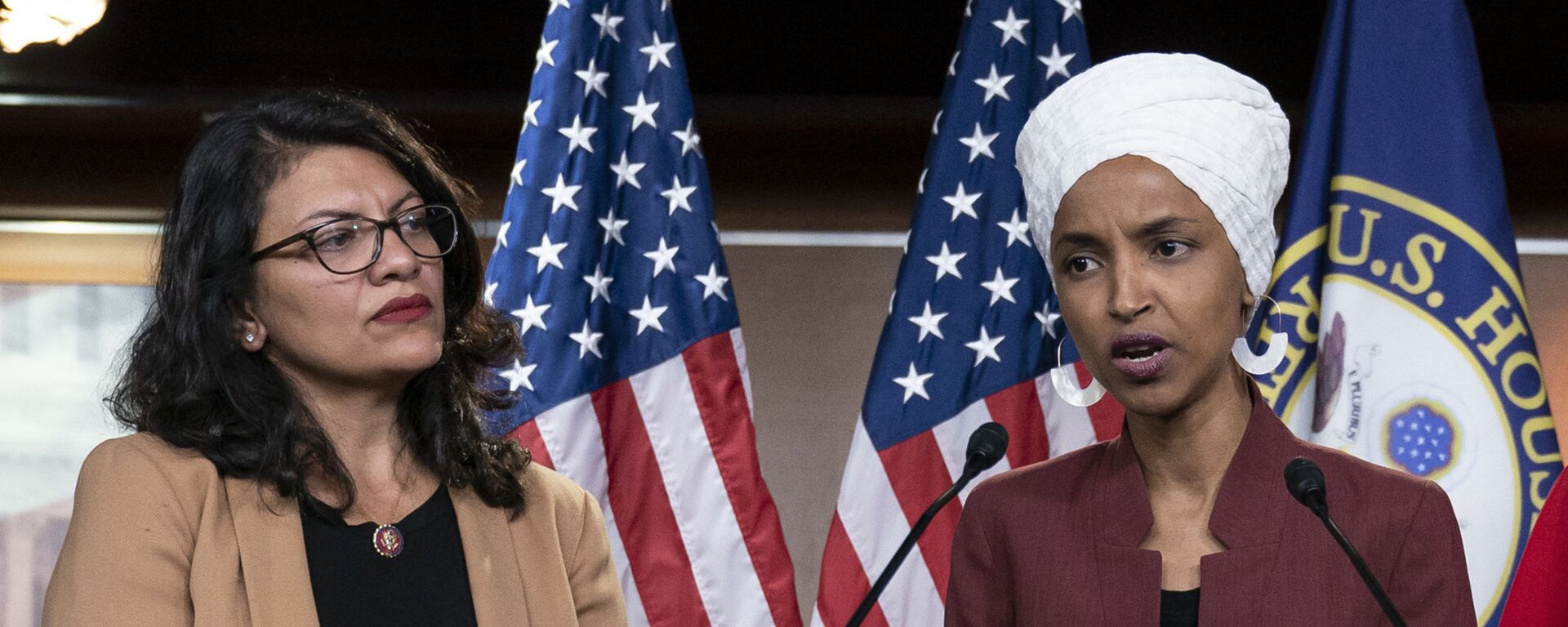 In this July 15, 2019, file photo, U.S. Rep. Ilhan Omar, D-Minn, right, speaks, as U.S. Rep. Rashida Tlaib, D-Mich. listens, during a news conference at the Capitol in Washington. - Sputnik India, 1920, 22.06.2023