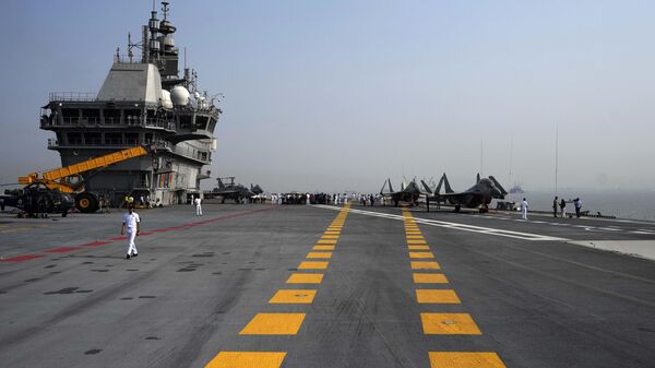 A navel officer walks on the deck of India's first Indigenous Aircraft Carrier INS Vikrant in Mumbai, India, Friday, March 10, 2023. - Sputnik भारत