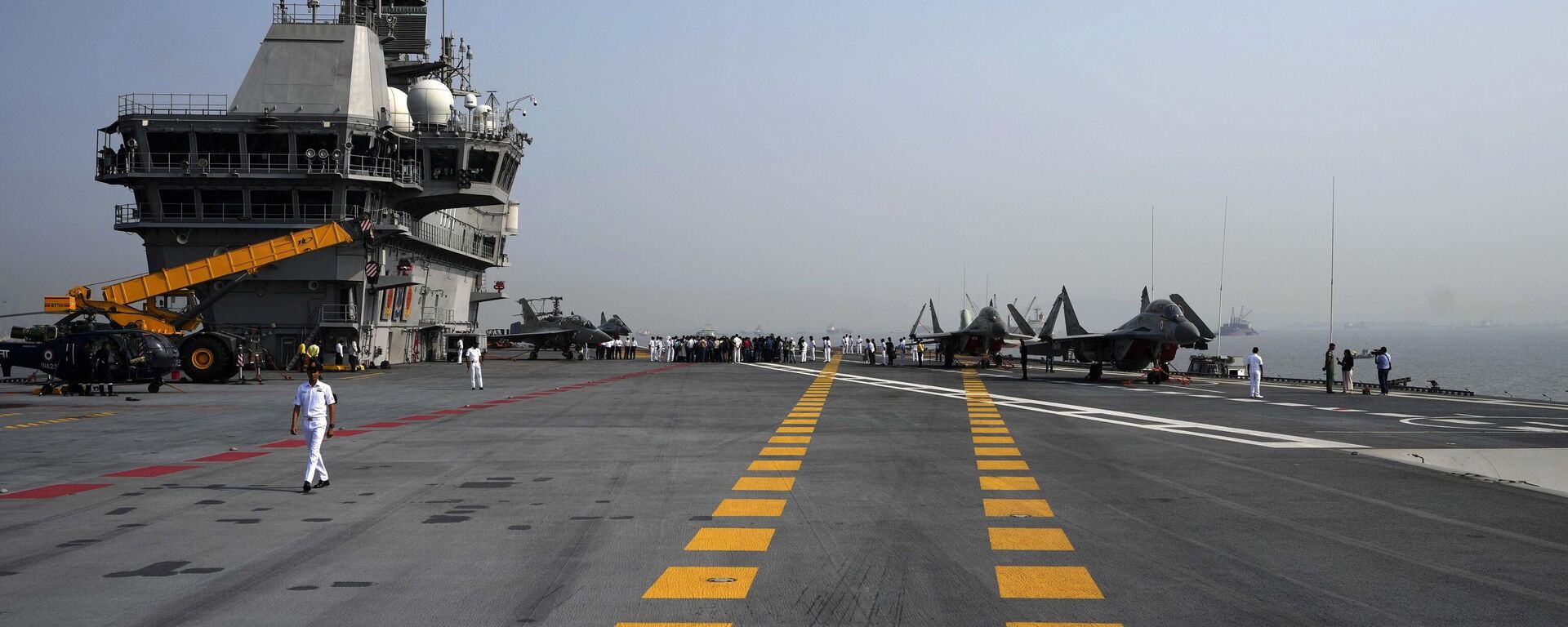 A navel officer walks on the deck of India's first Indigenous Aircraft Carrier INS Vikrant in Mumbai, India, Friday, March 10, 2023. - Sputnik भारत, 1920, 01.09.2023