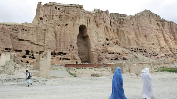 FILE - In this June 17, 2009 file photo, two women walk past the cliffs that once held giant Buddhas destroyed by the Taliban in 2001 in Bamiyan, central Afghanistan - Sputnik India