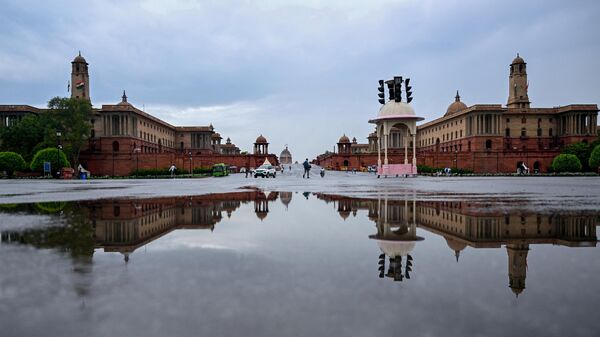 India’s Presidential Palace is reflected on a puddle of water after rains in New Delhi, on June 19, 2023. - Sputnik India