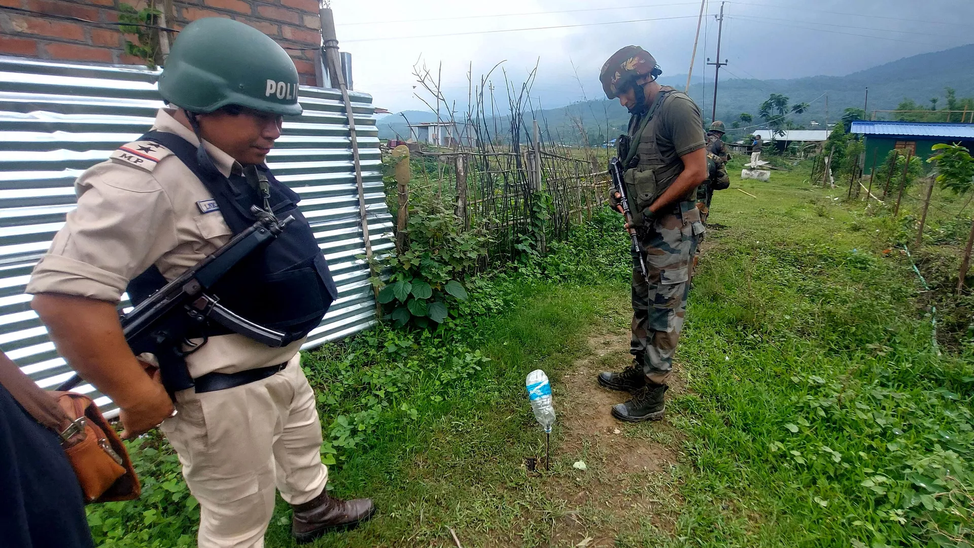 Indian Army and police personnel patrol during a combing operation at Kanto Sabal village near Imphal