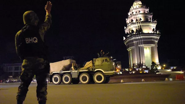 Cambodian soldier waves to others sitting on a rocket launcher truck - Sputnik भारत