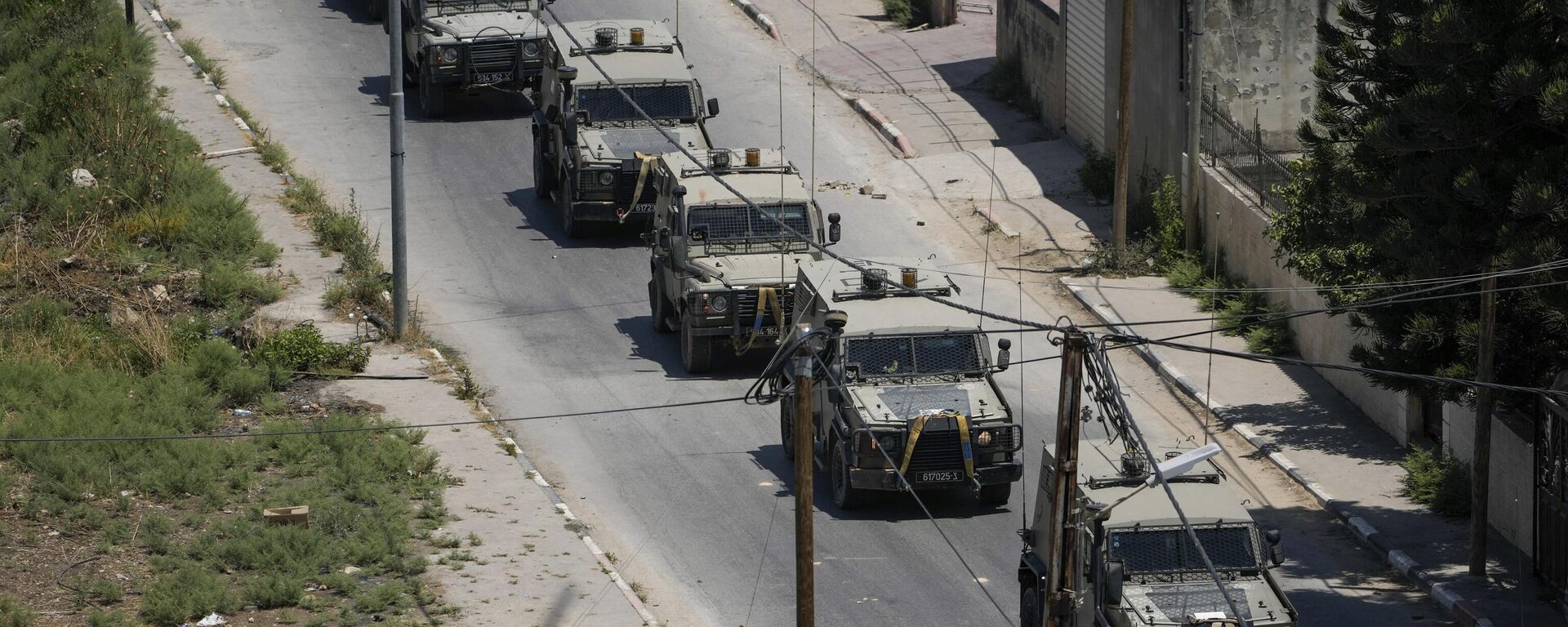 A convoy of army vehicles is seen during an Israeli military raid on the militant stronghold of the Jenin refugee camp in the occupied West Bank, Monday, July 3, 2023. Israeli drones struck targets and deployed hundreds of troops in the area in the largest operation in the area in more than a year of fighting. Palestinian health officials said at least eight Palestinians were killed. - Sputnik भारत, 1920, 04.07.2023