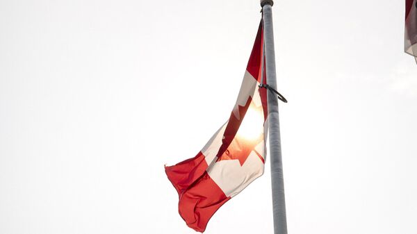 The sun passes through a Canadian flag at the chalet on top of the Mont Royal in Montreal - Sputnik India