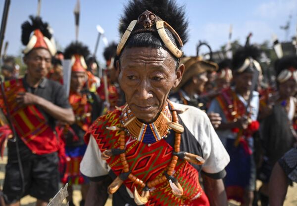 8 अप्रैल, 2023 को भारत के नागालैंड राज्य के मोन जिले के लोंगवा गांव में कोन्याक जनजाति के लोग बंदूक और दरांती लिए अपनी सामुदायिक सभा में नृत्य करते हैं। (Photo by Arun SANKAR / AFP) - Sputnik भारत