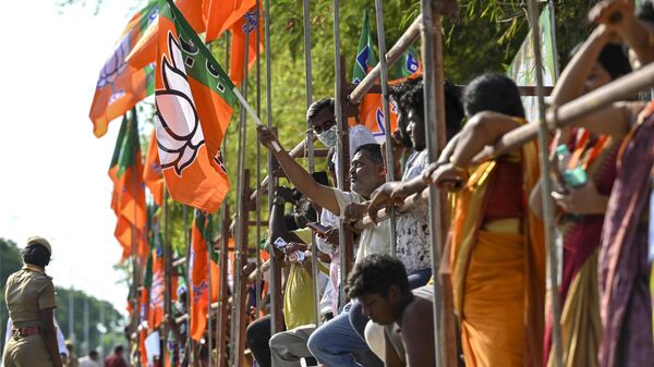 Bharatiya Janata Party (BJP) supporters await the arrival of India's Prime Minister Narendra Modi, along a street in Chennai on April 8, 2023.  - Sputnik भारत
