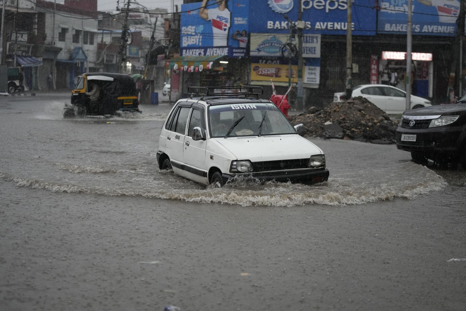 A car navigates its way through a flooded a street in Jammu, India - Sputnik India, 1920, 25.08.2023
