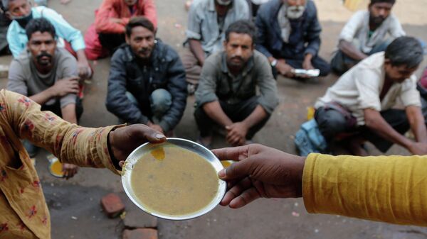 People wait for free food outside an eatery in Ahmedabad, India, on Jan. 20, 2021  - Sputnik India