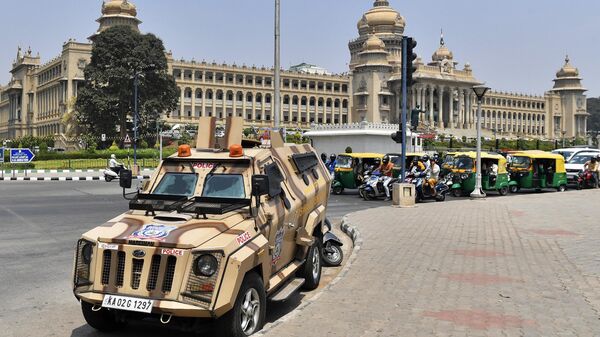 An armoured police vehicle is seen parked outside the Karnataka Vidhana Soudha, Karnataka's legislative building, in Bangalore on March 15, 2022, after an Indian court upheld a local ban on the hijab in classrooms, weeks after the edict stoked violent protests and renewed fears of discrimination against the country's Muslim minority.  - Sputnik भारत